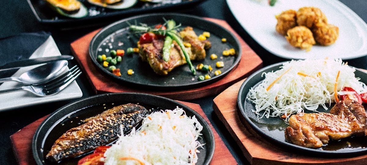 Rangée de pintxos variés sur un comptoir de bar basque, verres de vin